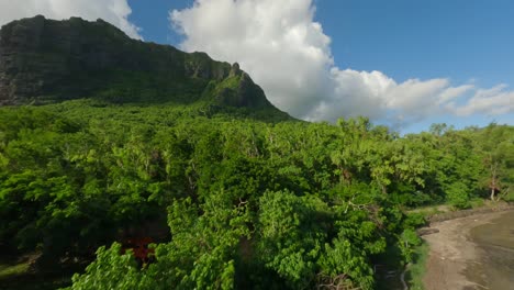 Vuelo-De-Proximidad-De-Un-Drone-Sobre-La-Playa-Hacia-La-Montaña-Le-Morne-Brabant