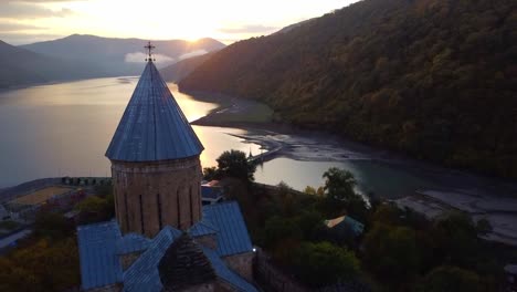 Drohnenaufnahme-Des-Seunrise-In-Einer-Kleinen-Stadt-Mit-See-Und-Kirche