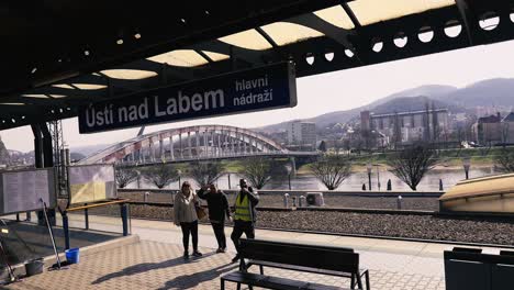 Smiling-people-waving-and-smiling-at-the-camera-on-train-station-Ústí-nad-Labem,-Czech-Republic-going-to-Prague