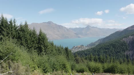 Lake-Wakatipu,-forests-and-mountains-on-a-sunny-summer-day-in-Queenstown,-New-Zealand