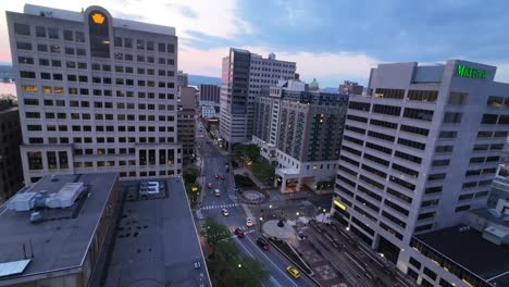FPV-flight-over-main-street-of-american-downtown-during-sunset-time