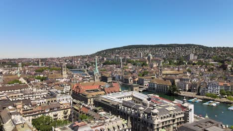 Drone-flyover-shot-over-the-city-of-Zürich-in-Switzerland-on-a-hot-summer-day