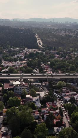 Vertical-mode,-slow-motion-aerial-view-of-CDMX-streets,-avenues,-and-traffic