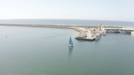 Smooth-orbit-around-a-sailboat-capturing-the-sea,-dock,-and-passing-seagulls