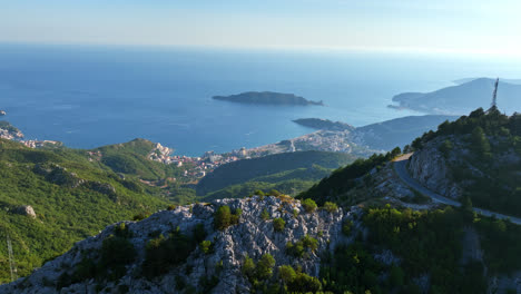 Aerial-view-overlooking-the-mountainous-coastline-of-Budva,-Montenegro,-sunny-day