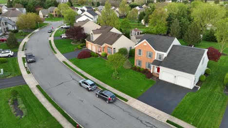 Drone-flight-over-street-with-parking-cars-in-american-neighborhood