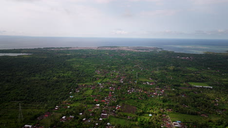 Aerial-pullback-above-main-city-center-of-Banyuwedang-village-on-coast-of-Bali