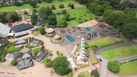 Aerial-pullback-shot-of-rides-and-giant-wheel-in-Wicksteed-park-n-England