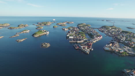 Fantastic-aerial-view-over-the-city-of-Henningsvaer-and-its-small-islands,-with-beautiful-sunset-colors