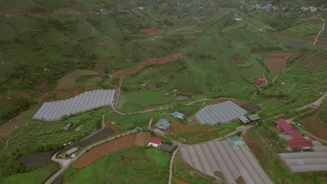 Agricultural-greenhouse-on-the-hillside-of-Sa-Pa-in-Vietnam's-Hoàng-Liên-Son-Mountains,-supporting-sustainable-farming-practices-amidst-the-breathtaking-natural-landscape