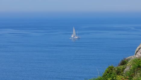 Sailboat-On-Atlantic-Ocean-Seen-From-Coast-Of-Pontevedra-In-Galicia,-Spain