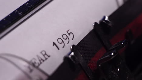 Year-1995,-Typing-on-Blank-White-Paper-in-Vintage-Typewriter,-Close-Up