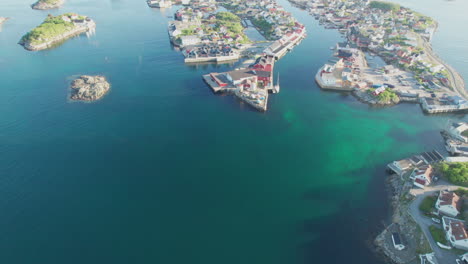 Fantastic-aerial-view-revealing-the-city-of-Henningsvaer,-with-beautiful-sunset-colors