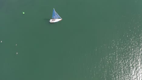 El-Dron-Asciende-Y-Orbita,-Centrándose-En-Un-Velero-Navegando-En-El-Mar.