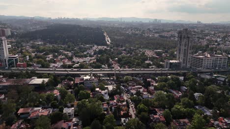 Slow-motion-aerial-view-of-Mexico-City's-streets,-avenues,-and-traffic