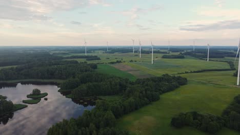 Sky-reflecting-on-lake-near-wind-turbine-farm,-aerial-view