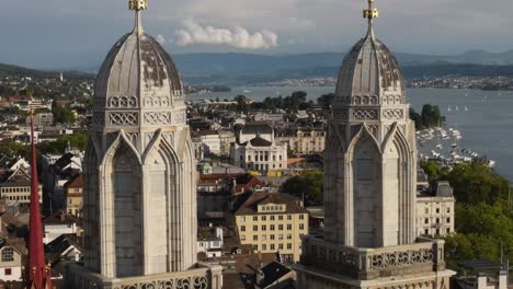 Zoomed-in-drone-shot-flying-towards-Grossmunster-cathedral-towers-and-Opera-House-in-Zürich-Switzerland