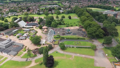 Aerial-pan-shot-of-Wicksted-park-with-giant-wheel-and-rides-in-England