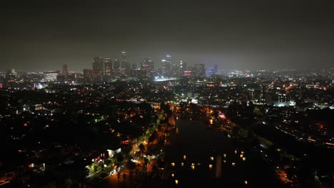 Downtown-Los-Angeles-skyline-illuminated-at-night,-aerial-panoramic-view