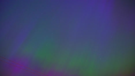 Vibrant-purple-and-green-colors-of-Aurora-borealis-on-night-sky,-time-lapse-view