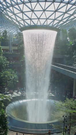 Vertical-Video-of-The-Magnificent-Rain-Vortex-Waterfall-Located-At-Jewel-Changi-Airport-Singapore