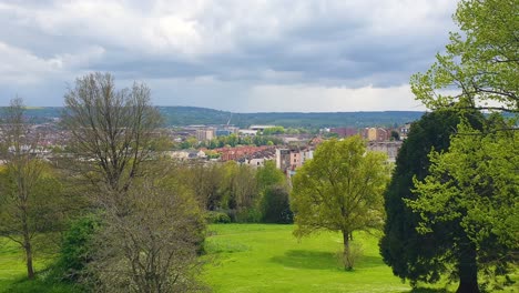 Scenic-view-through-green-trees-and-gardens-of-Brandon-Hill-Park-overlooking-the-city-of-Bristol-in-England-UK