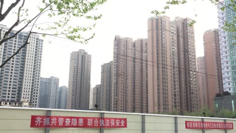 Tall-housing,-skyscrapers-and-blocks-of-flats,-where-people-live-in-Shanghai,-China,-panning-shot