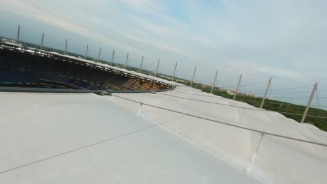 FPV-Drone-flying-over-roof-from-Stadium-HSV-Hamburg-dropping-down-onto-goal