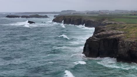 Drone,aerial-As-Catedrais-,-Cathedrals-beach-Northern-Spain-tide-out-dramatic-waves-breaking