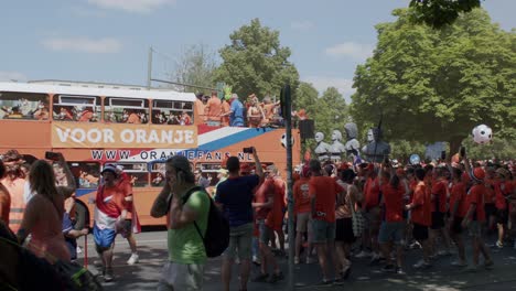 Dutch-football-fans-parade-with-an-orange-bus-during-Euro-2024