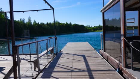 Moving-footage-of-a-wooden-boat-dock-on-a-rural-lake-in-Estonia,-Harjumaa,-Europe,-Baltics-in-4k