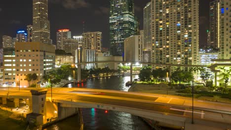 Miami-River,-downtown-skyscrapers,-and-city-traffic-in-Miami,-Florida-at-night