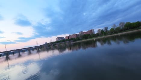 Drone-flight-through-arches-of-bridge-over-Susquehanna-River-during-sunrise-in-Harrisburg-City,-USA