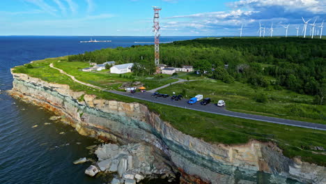 Pakri-cliff,-paldiski,-estonia,-with-cars,-wind-turbines,-and-ocean-scenery,-aerial-view