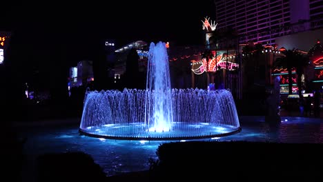 Las-Vegas-USA,-Caesars-Palace-Fountain-at-Night,-Lights-on-Water-and-Strip-Buildings