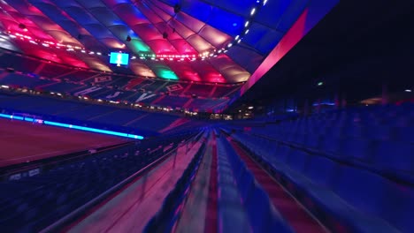 FPV-Drone-flying-over-empty-seats-in-Hamburg-HSV-Stadium-under-light-show-EURO2024