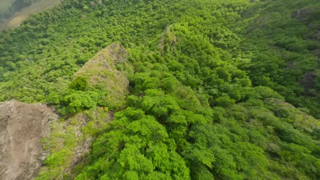 Drone-flying-close-to-the-rocks-towards-the-lagoon-at-Le-Morne-Brabant,-Mauritius