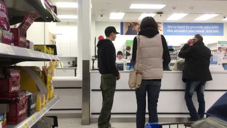 Motion-of-people-picking-up-for-their-medicine-at-pharmacy-section-inside-Walamrt-store-with-4k-resolution