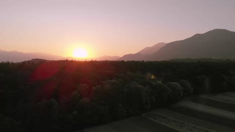 Orange,-red,-white-sunset-behind-mountains-in-Slovenia