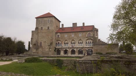 Wide-establishing-dolly-shot-of-Tata-Castle-with-the-garden-in-the-foreground,-Tata,-Hungary