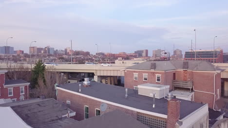 Aerial-shot-rising-up-from-behind-a-highway-to-reveal-Wilmington-Delaware