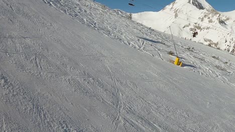 Skier-on-a-slope-with-ski-lift-in-the-background-on-a-sunny-day