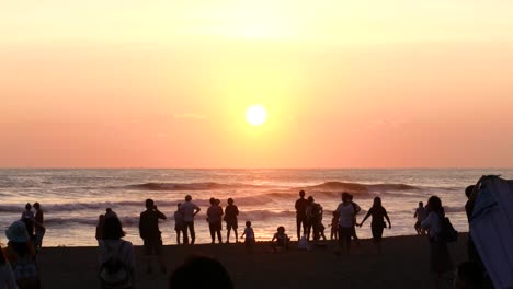 Beach-in-Taiwan-with-people-looking-at-the-sunset-from-the-shore