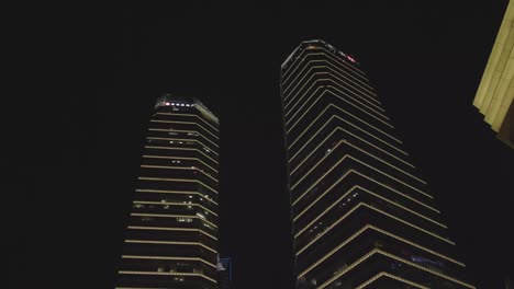 Low-angle-view-of-two-skyscrapers-in-shanghai,-China-at-night