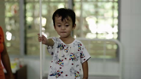 cute-shy-burmese-child-waiting-in-a-hospital
