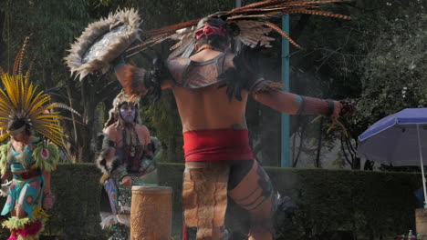 Tilt-Down-Reveal-of-Aztec-Dancer-Putting-Foot-in-Flame-During-Fire-Dance