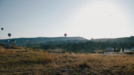 HOT-AIR-BALLOONS-ARE-TRAVELING-IN-VALLEY