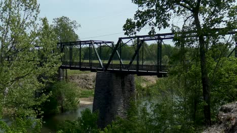 Old-pedestrian-bridge-over-river