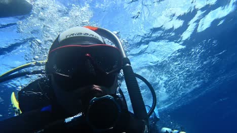 Fixing-a-mask-by-a-scuba-diver-after-entering-the-sea