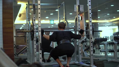 Young-man-performing-Leg-Barbell-squat